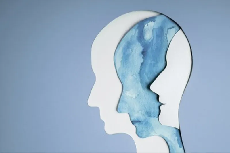 Paper-cut illustration of two overlapping human head profiles