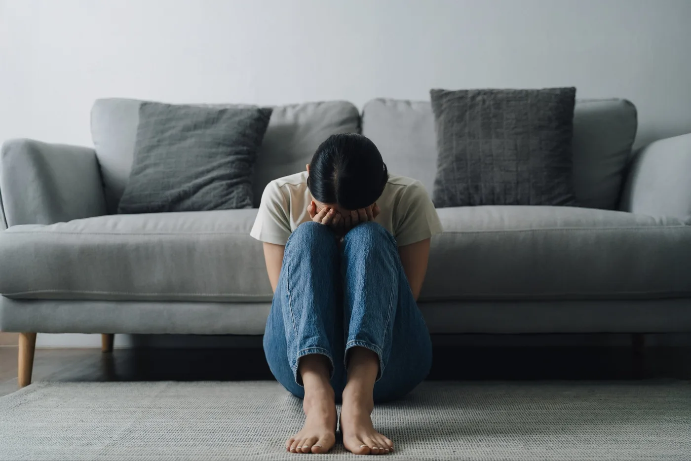 woman is sitting on the floor in a living room